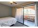 Cozy bedroom with private patio, featuring a neutral color palette and peaceful outdoor access at 4303 E Cactus Rd # 308B, Phoenix, AZ 85032