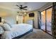Relaxing bedroom with private outdoor access and en-suite bathroom, complete with television and furnishings at 4303 E Cactus Rd # 308B, Phoenix, AZ 85032
