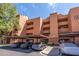 Apartment building featuring covered parking, ample parking spaces and a building number at 4303 E Cactus Rd # 308B, Phoenix, AZ 85032