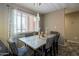 Bright dining area featuring a modern chandelier, decorative centerpiece, and window with stylish curtains at 4303 E Cactus Rd # 308B, Phoenix, AZ 85032