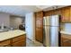 Kitchen with a large refrigerator and wood cabinets at 4303 E Cactus Rd # 308B, Phoenix, AZ 85032