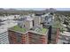 Overhead view of a building with a rooftop patio that includes outdoor seating and beautiful city skyline at 4808 N 24Th St # 1305, Phoenix, AZ 85016