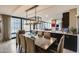 Spacious dining area with a large table, modern chandelier, and views through expansive windows at 4808 N 24Th St # 1305, Phoenix, AZ 85016