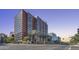 Modern high-rise building featuring extensive glass facade and street-level palm tree landscaping at 4808 N 24Th St # 1305, Phoenix, AZ 85016