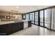 Contemporary kitchen with stainless steel appliances, marble countertops, and large windows offering city views at 4808 N 24Th St # 1305, Phoenix, AZ 85016