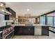 Modern kitchen with stainless steel appliances and marble countertops, open to a dining area with stunning views at 4808 N 24Th St # 1305, Phoenix, AZ 85016