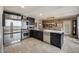 Modern kitchen equipped with stainless steel appliances, marble countertops, and ample cabinet space, open to dining area at 4808 N 24Th St # 1305, Phoenix, AZ 85016