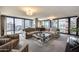 Modern living room with plush seating, a glass coffee table, and expansive windows with cityscape views at 4808 N 24Th St # 1305, Phoenix, AZ 85016