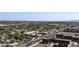 This aerial view captures surrounding neighborhoods near property with distant mountain views at 4808 N 24Th St # 1305, Phoenix, AZ 85016