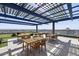 A rooftop patio featuring outdoor seating under a solar panel canopy with city views at 4808 N 24Th St # 1305, Phoenix, AZ 85016