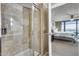 Walk-in shower with a glass door, tiled walls, and modern fixtures, located within the main bathroom at 4808 N 24Th St # 1305, Phoenix, AZ 85016