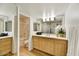 Bright bathroom featuring wood cabinets, a shower with glass door, a sink, and a large mirror at 5104 N 32Nd St # 431, Phoenix, AZ 85018