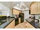 Well-lit kitchen with granite counters, wood cabinets, and modern appliances at 5104 N 32Nd St # 431, Phoenix, AZ 85018
