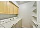 Functional laundry room with washer, dryer, shelving, and cabinet space at 5104 N 32Nd St # 431, Phoenix, AZ 85018
