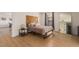A well lit bedroom featuring a decorative headboard, full sized mirror and open doorway at 5122 N 31St Way # 238, Phoenix, AZ 85016