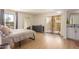 Bright main bedroom with wood floors, balcony access, and an ensuite bathroom at 5122 N 31St Way # 238, Phoenix, AZ 85016
