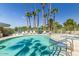 Large community pool and jacuzzi with lush landscaping and tall palm trees at 5122 N 31St Way # 238, Phoenix, AZ 85016