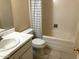 Neutral bathroom featuring a tiled floor, a white bathtub with shower and a vanity with a white countertop at 5910 N 86Th St, Scottsdale, AZ 85250