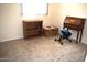 Bedroom with neutral carpet, natural light, and decorative shelving and desk at 5910 N 86Th St, Scottsdale, AZ 85250
