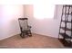 Bedroom with a wooden rocking chair, neutral carpet, and a decorative shelving unit at 5910 N 86Th St, Scottsdale, AZ 85250