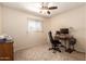 Neutral carpeted bedroom featuring a ceiling fan, window, and desk area at 5910 N 86Th St, Scottsdale, AZ 85250