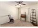 Neutral carpeted bedroom with ceiling fan and decorative furniture at 5910 N 86Th St, Scottsdale, AZ 85250