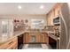 Modern kitchen features updated appliances, custom cabinets, a stylish backsplash, and elegant granite countertops at 5910 N 86Th St, Scottsdale, AZ 85250