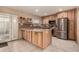 Spacious kitchen with custom cabinets, stainless steel appliances, granite countertops, and a large island at 5910 N 86Th St, Scottsdale, AZ 85250