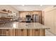Well-lit kitchen features stainless steel appliances, wood cabinets, and granite countertops at 5910 N 86Th St, Scottsdale, AZ 85250