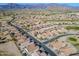 Expansive aerial view of a desert community with a golf course, houses, and mountain views at 6513 S Fairway Dr, Gold Canyon, AZ 85118