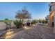 Beautiful backyard with a stone-paved patio, lush desert landscaping, and cozy outdoor lighting at 6513 S Fairway Dr, Gold Canyon, AZ 85118