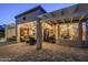 Backyard featuring a covered patio with cozy seating, a grill, and a glimpse of the home's interior at 6513 S Fairway Dr, Gold Canyon, AZ 85118