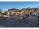 Backyard view showcases an extended covered patio and lush desert landscape at 6513 S Fairway Dr, Gold Canyon, AZ 85118
