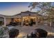 Inviting backyard features a covered patio with comfortable seating, a grill, and stylish outdoor lighting at 6513 S Fairway Dr, Gold Canyon, AZ 85118