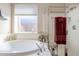 Bright bathroom featuring a soaking tub, glass enclosed shower, and a large window at 6513 S Fairway Dr, Gold Canyon, AZ 85118