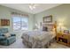 Bedroom with a ceiling fan, large window view, and bedside tables with lamps at 6513 S Fairway Dr, Gold Canyon, AZ 85118