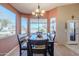 Bright dining room with large windows offering scenic views and comfortable seating for six at 6513 S Fairway Dr, Gold Canyon, AZ 85118