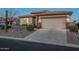 Charming exterior featuring a two-car garage, stone accents, and a cozy patio space at 6513 S Fairway Dr, Gold Canyon, AZ 85118