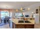 Kitchen with granite countertops, stainless steel appliances, and bar seating overlooking the dining room at 6513 S Fairway Dr, Gold Canyon, AZ 85118