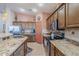Well-equipped kitchen with granite countertops, stainless steel appliances, and a tiled backsplash at 6513 S Fairway Dr, Gold Canyon, AZ 85118