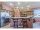 Charming kitchen with stainless steel appliances, a breakfast bar, and tile flooring at 6513 S Fairway Dr, Gold Canyon, AZ 85118