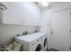 Laundry room with a washer and dryer and ample storage cabinets at 6513 S Fairway Dr, Gold Canyon, AZ 85118