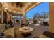 Charming covered patio area with a stone fire pit, perfect for outdoor relaxation and entertaining at 6513 S Fairway Dr, Gold Canyon, AZ 85118