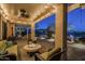 Cozy covered patio with a stone fire pit, comfortable seating, and inviting outdoor ambiance at 6513 S Fairway Dr, Gold Canyon, AZ 85118