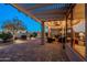Relaxing covered patio with comfortable seating, a fire pit, and serene outdoor ambiance at 6513 S Fairway Dr, Gold Canyon, AZ 85118