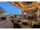 Inviting covered patio features stylish wicker furniture, a cozy fire pit, and serene outdoor ambiance at 6513 S Fairway Dr, Gold Canyon, AZ 85118