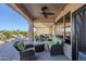 Spacious covered patio with seating area, ceiling fan, and access to the backyard at 6513 S Fairway Dr, Gold Canyon, AZ 85118