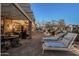 Relaxing outdoor patio features lounge chairs, dining area, and covered seating with scenic views at 6513 S Fairway Dr, Gold Canyon, AZ 85118