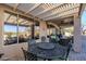 Covered patio with dining and seating areas overlooking the desert landscape at 6513 S Fairway Dr, Gold Canyon, AZ 85118