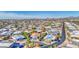 Expansive aerial view of the neighborhood showcasing residential homes and streets against a mountain backdrop at 654 S 83Rd Way, Mesa, AZ 85208